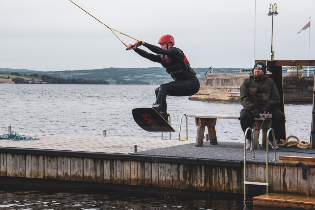 Ung mann prøver wakeboard kabelbane